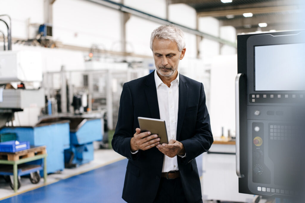 Manager using digital tablet in high-tech company