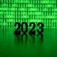 The numbers 2023 backlit by green binary code