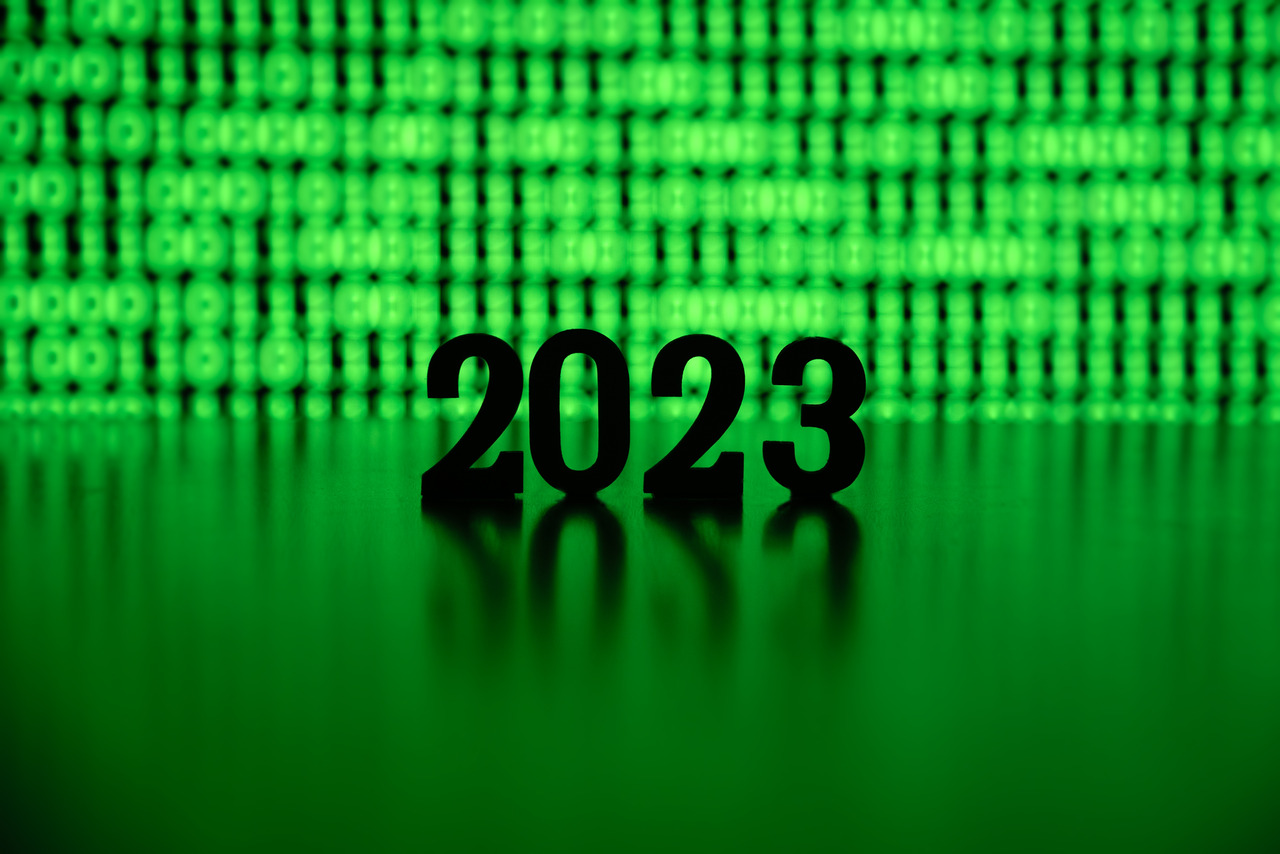 The numbers 2023 backlit by green binary code
