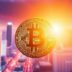 Golden Bitcoin coin with digital cityscape background.