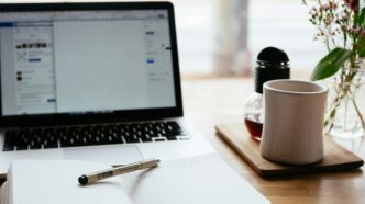 MacBook Pro near white open book