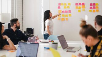 woman placing sticky notes on wall