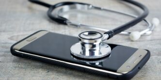 a smart phone with a stethoscope on top of it