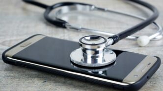 a smart phone with a stethoscope on top of it