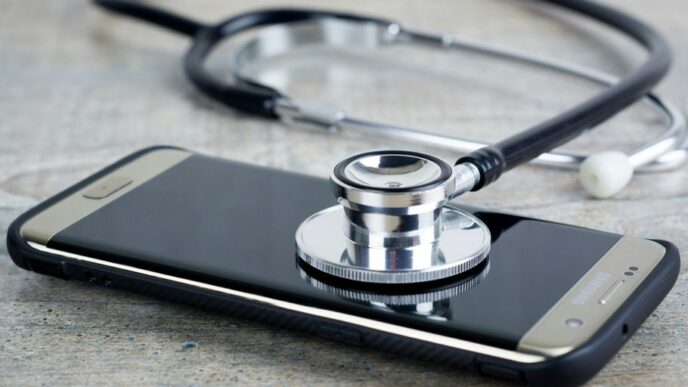 a smart phone with a stethoscope on top of it