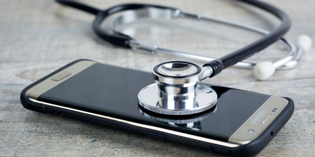 a smart phone with a stethoscope on top of it