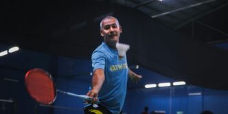 man in blue crew neck t-shirt and black shorts holding red basketball