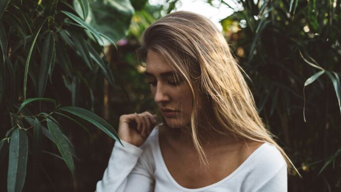 woman near green leafed plants