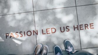 two person standing on gray tile paving