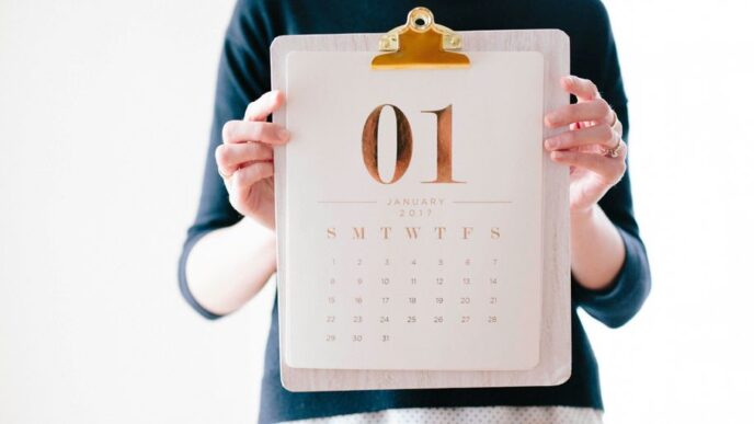 person holding calendar at January