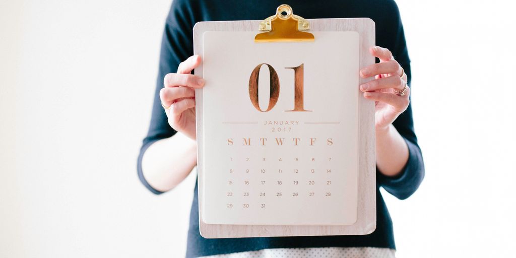 person holding calendar at January