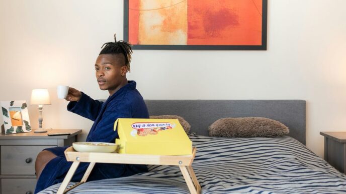man sits on bed