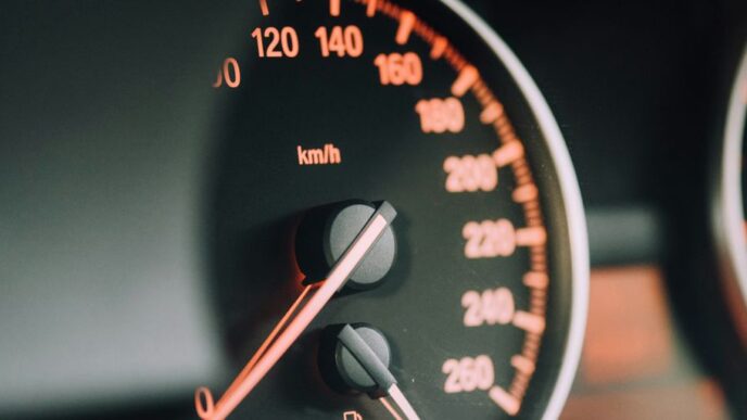 closeup photo of black analog speedometer