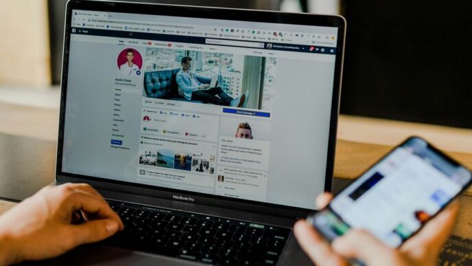 person using both laptop and smartphone