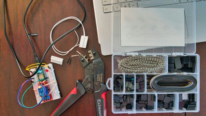 red and silver scissors beside white laptop computer