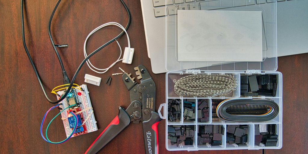 red and silver scissors beside white laptop computer