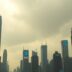 Futuristic city skyline with cloudy skies and tech logos.