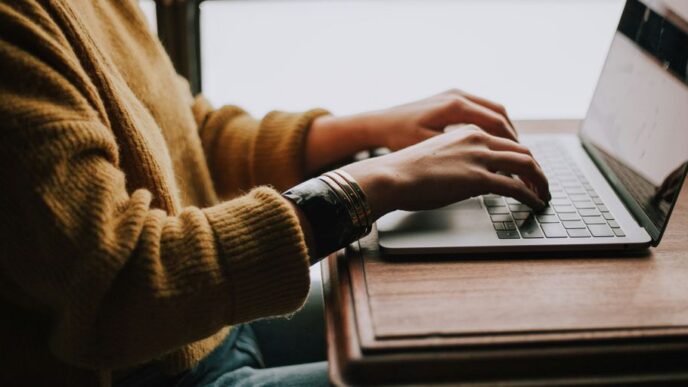person sitting front of laptop