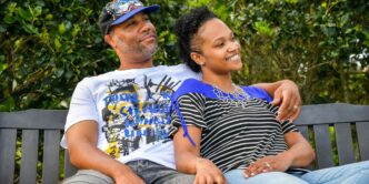 man in white crew neck t-shirt sitting beside woman in black and white stripe shirt