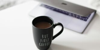 selective focus photo of filled black ceramic mug