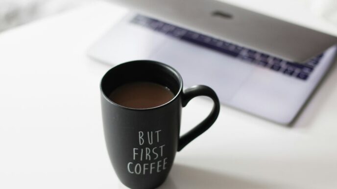 selective focus photo of filled black ceramic mug