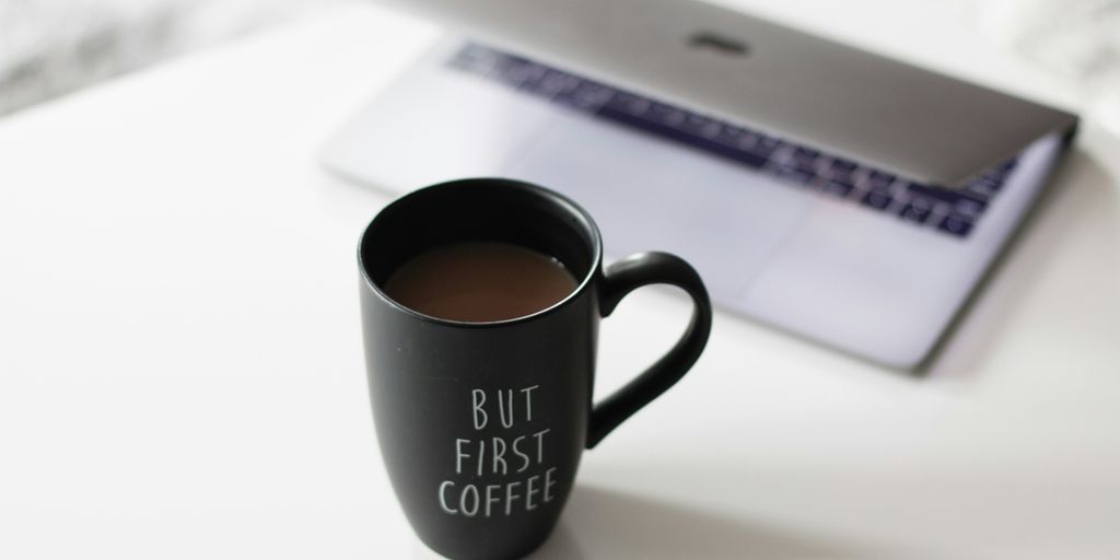 selective focus photo of filled black ceramic mug