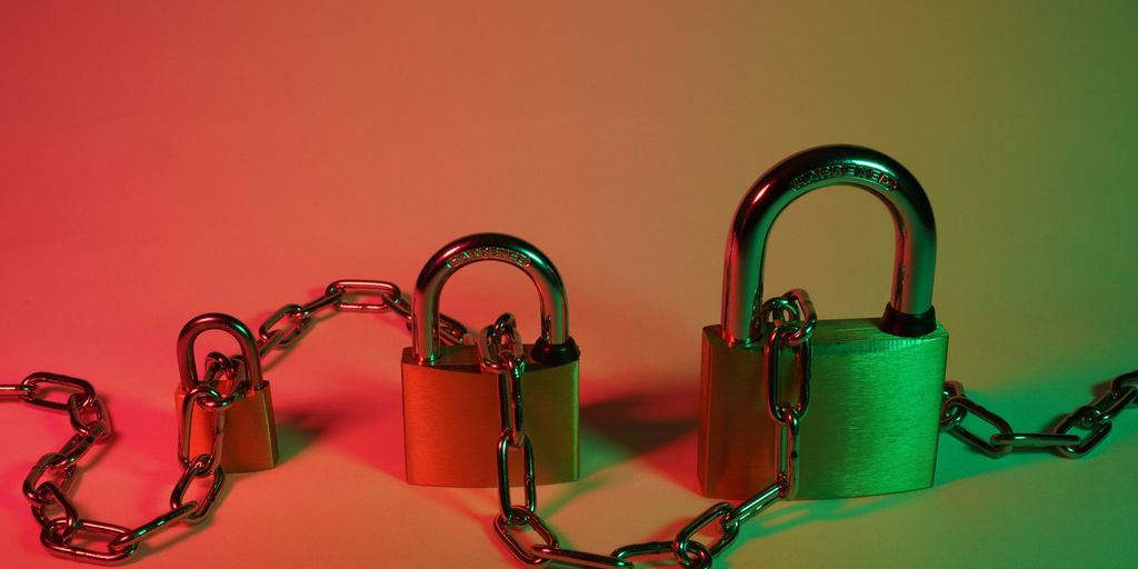 green padlock on pink surface