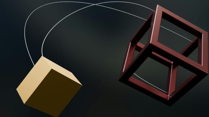 A picture of a cube and a box hanging from a string