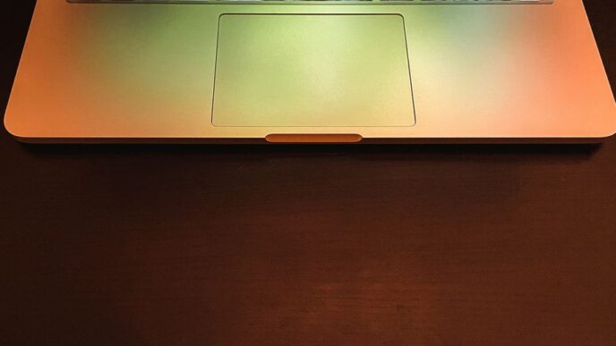 macbook pro on brown wooden table