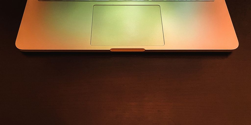 macbook pro on brown wooden table
