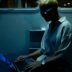 A man sitting on a train using a laptop computer