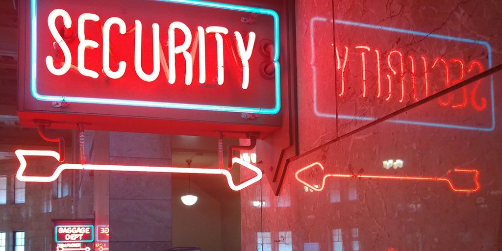 a red security sign and a blue security sign