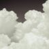 a plane flying through a cloud filled sky