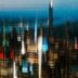 Blurred cityscape with bright lights at night.