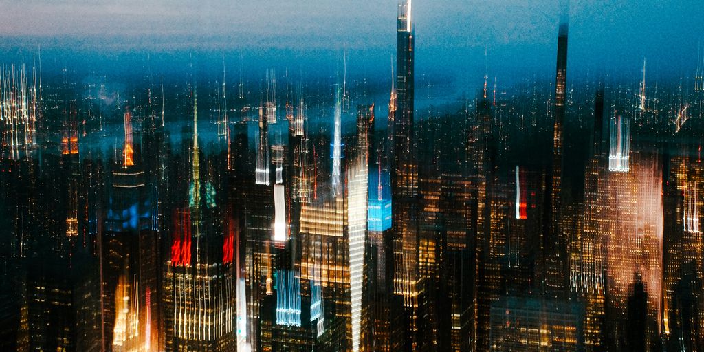 Blurred cityscape with bright lights at night.