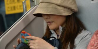 woman in white jacket wearing brown cap