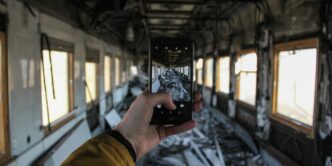 a man taking a picture of a train