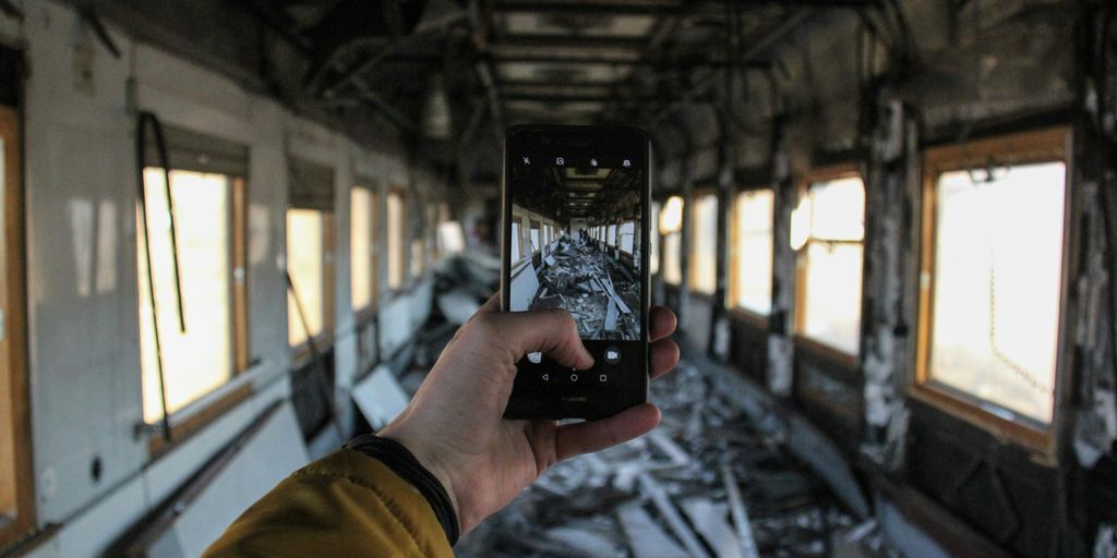 a man taking a picture of a train