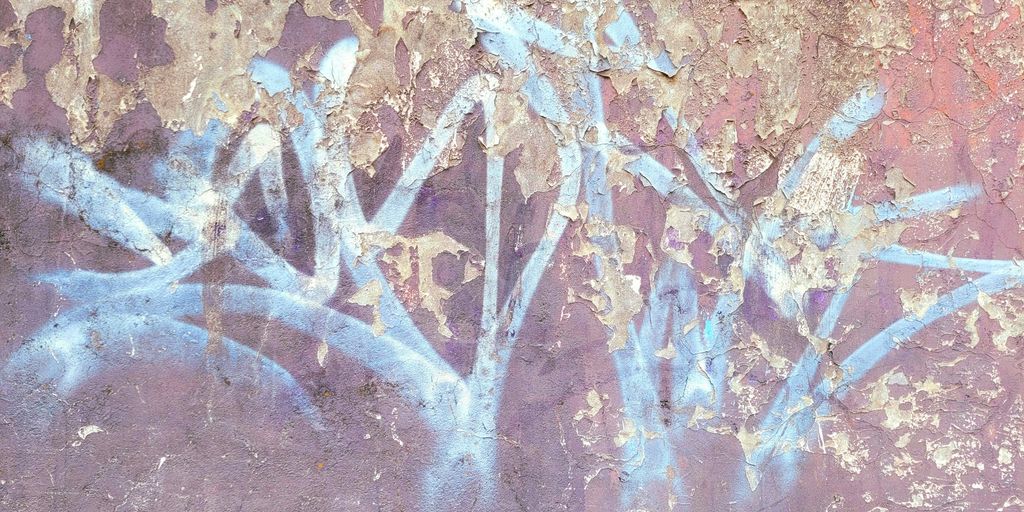 a painting of a flower on the side of a wall