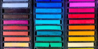 a box filled with lots of different colored crayons