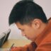 man in orange hoodie using smartphone