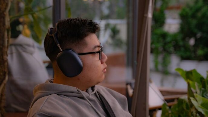 A young man listens to music outdoors.