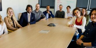 group of people sitting on chair in front of brown wooden table