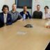 group of people sitting on chair in front of brown wooden table