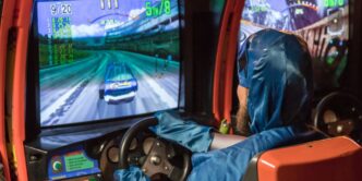 man in blue jacket driving car