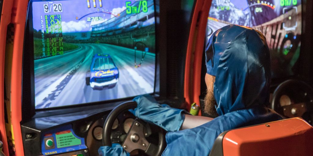 man in blue jacket driving car