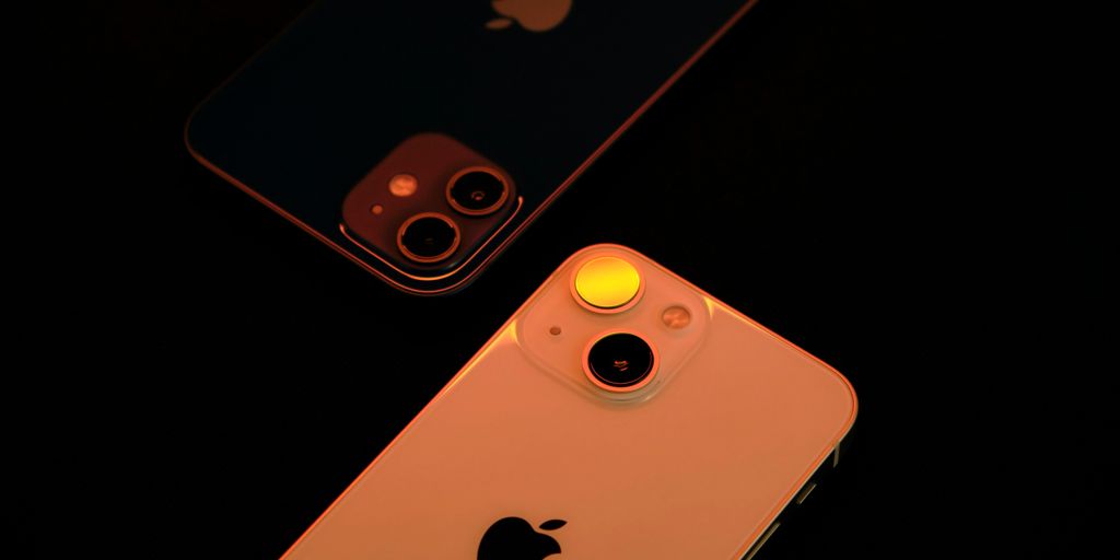 two iphones sitting next to each other on a table