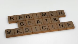 scrabble tiles spelling the word regimen beats medicine