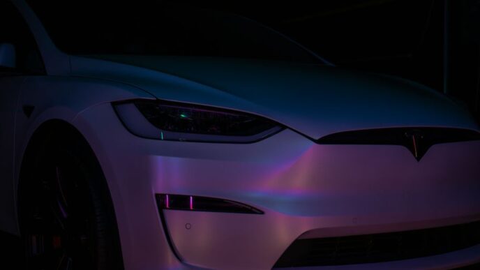 A white car parked in a dark room
