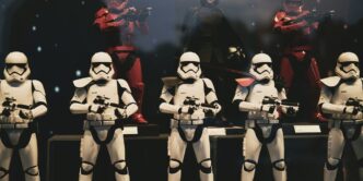3 women in white and black costume standing on stage
